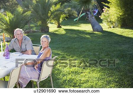 Stock Image - Family at an outdoor meal. Fotosearch