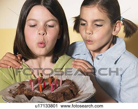 Girls holding a birthday cake View Large Photo Image Stock Image - Girls holding a birthday cake. Fotosearch