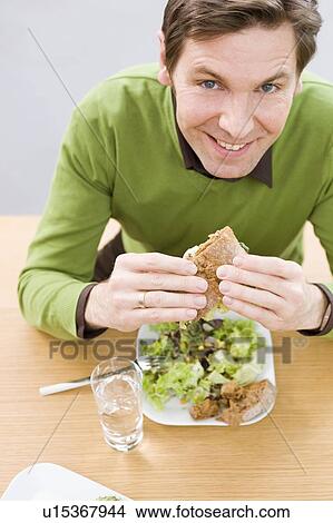 Man eating health food View Large Photo Image Picture - Man eating health food. Fotosearch