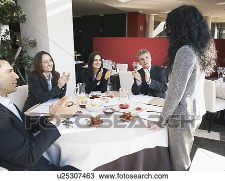 Stock Image - Mature businesswoman receiving applause. Fotosearch