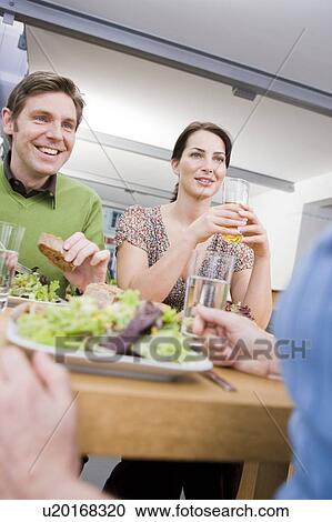 Stock Image - Team eating health food. Fotosearch