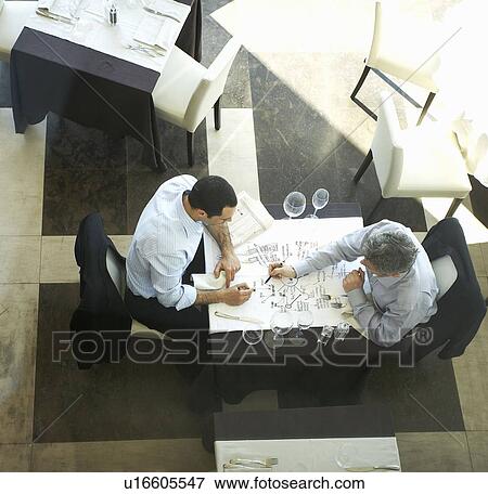 Stock Photo - Two businessmen writing on tablecloth. Fotosearch