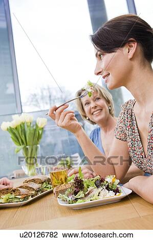 Two women eating health food View Large Photo Image Stock Image - Two women eating health food. Fotosearch