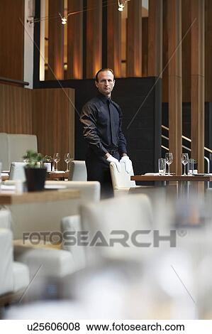 Stock Photo - Waiter by laid-out tables. Fotosearch
