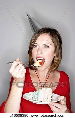 Woman eating birthday cake View Large Photo Image Stock Image - Woman eating birthday cake. Fotosearch