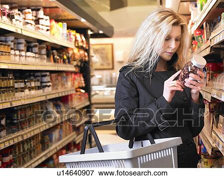 Stock Photo - Woman in a grocery store. Fotosearch