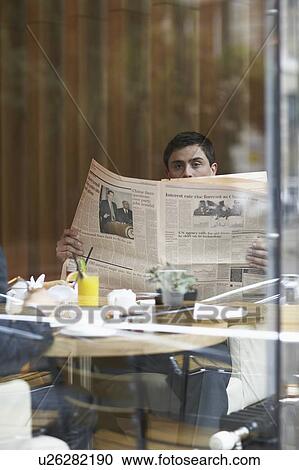 A businessman in a restaurant with a newspaper View Large Photo Image Stock Image - A businessman in a restaurant with a newspaper. Fotosearch
