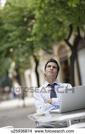 Business man at caf? with laptop View Large Photo Image Picture - Business man at caf? with laptop. Fotosearch