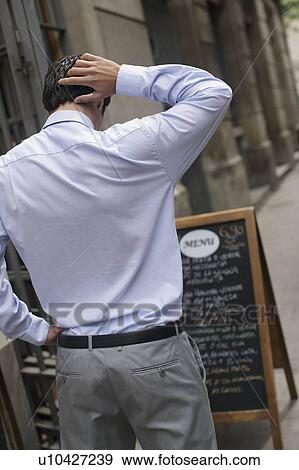 Stock Photo - Business man looking at menu. Fotosearch