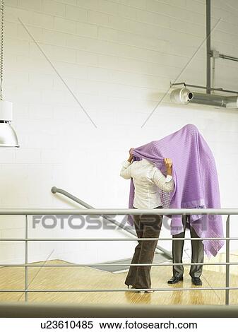 Stock Photography - Businesspeople under a blanket. Fotosearch