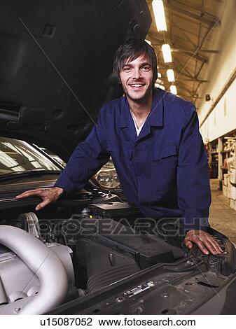 Stock Image - Mechanic working on an engine. Fotosearch