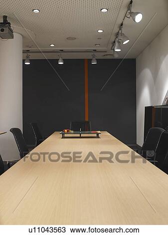 Stock Image - Miniature ping pong set on a boardroom table. Fotosearch