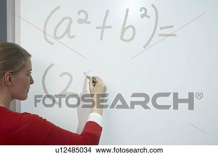 Teacher writing on whiteboard View Large Photo Image Picture - Teacher writing on whiteboard. Fotosearch