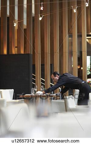 Waiter tidying up table composition View Large Photo Image Stock Image - Waiter tidying up table composition. Fotosearch