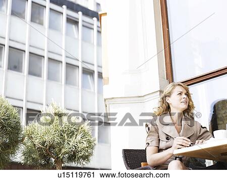 Stock Image - Woman at an outdoor restaurant. Fotosearch