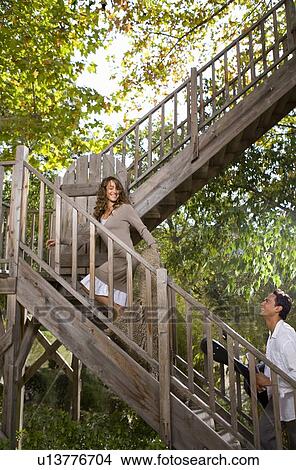 Couple escape up to tree house. View Large Photo Image Picture - Couple escape up to tree house. . Fotosearch