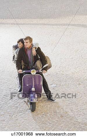 Stock Photo - Man and woman on scooter.. Fotosearch