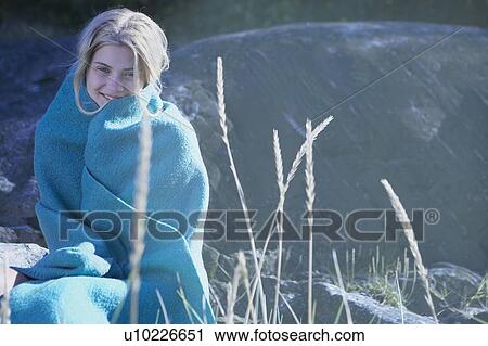 Stock Image - Young Woman wrapped in blanket.. Fotosearch