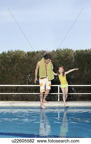 Father and girl dipping toes in pool View Large Photo Image Stock Image - Father and girl dipping toes in pool. Fotosearch