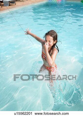 Girl jumping in swimming pool. View Large Photo Image Stock Image - Girl jumping in swimming pool.. Fotosearch