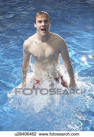 Stock Image - Man jumping up out of pool.. Fotosearch