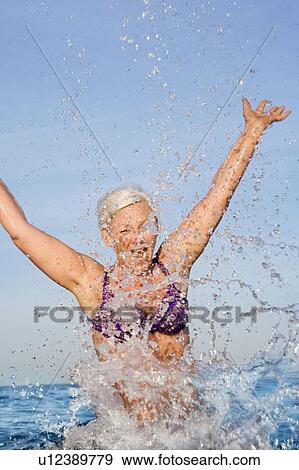 Stock Photo - Mature woman bathing. Fotosearch