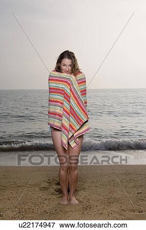 Woman with a towel on the beach. View Large Photo Image Stock Photo - Woman with a towel on the beach.. Fotosearch