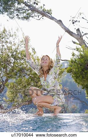 Young woman by poolside. View Large Photo Image Picture - Young woman by poolside.. Fotosearch