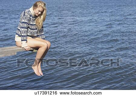 Stock Photograph - Young woman on diving platform.. Fotosearch