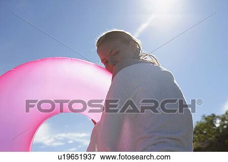Stock Photo - Young woman with swimming ring.. Fotosearch