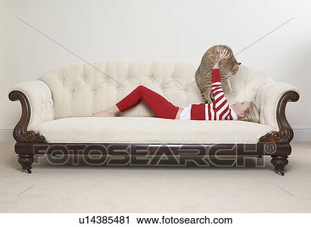 Girl and cat on sofa View Large Photo Image Stock Image - Girl and cat on sofa. Fotosearch