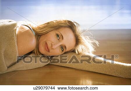 Mature woman relaxing in a gym View Large Photo Image Picture - Mature woman relaxing in a gym. Fotosearch
