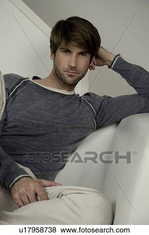 Stock Photo - Portrait of a man on a sofa. Fotosearch
