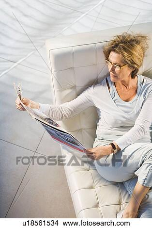 Picture - Woman Reading Newspapers. Fotosearch