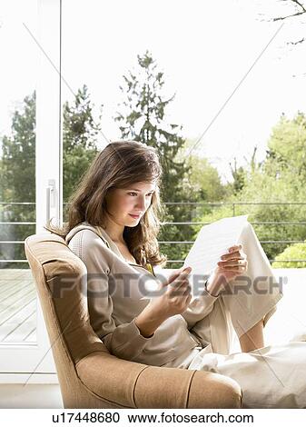 Young woman reading a letter View Large Photo Image Stock Image - Young woman reading a letter. Fotosearch