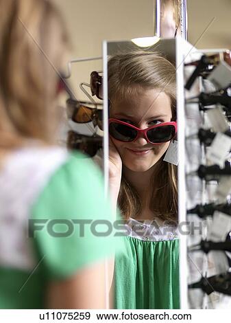 Girl trying sun glasses View Large Photo Image Stock Photo - Girl trying sun glasses. Fotosearch