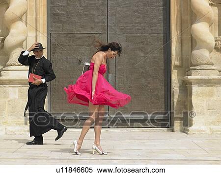 Priest passing woman whose skirt is blowing up in the wind, Alicante, Spain, View Large Photo Image Stock Photography - Priest passing woman whose skirt is blowing up in the wind, Alicante, Spain,. Fotosearch