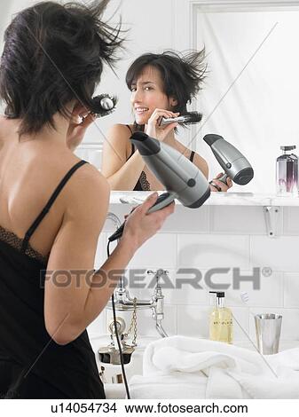 Woman drying her hair View Large Photo Image Picture - Woman drying her hair. Fotosearch