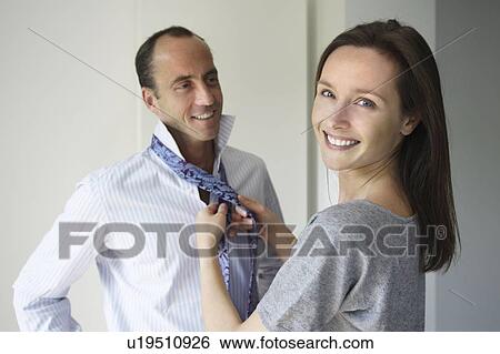Stock Photograph - Woman knotting her man's tie. Fotosearch