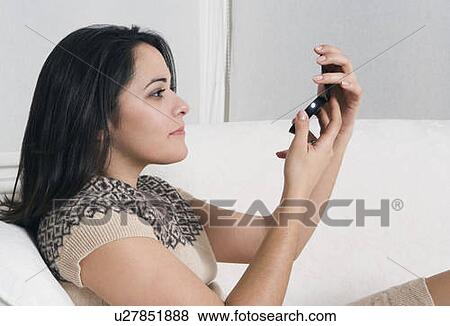 Woman looking in makeup mirror View Large Photo Image Stock Photo - Woman looking in makeup mirror. Fotosearch