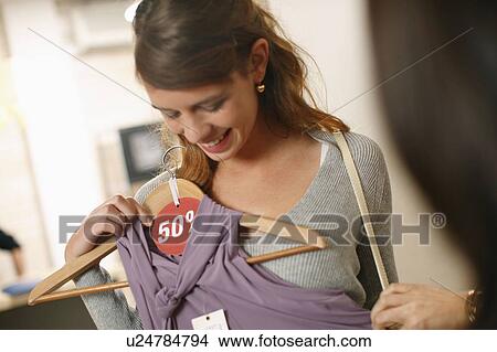 Picture - Young woman at clothes sale. Fotosearch