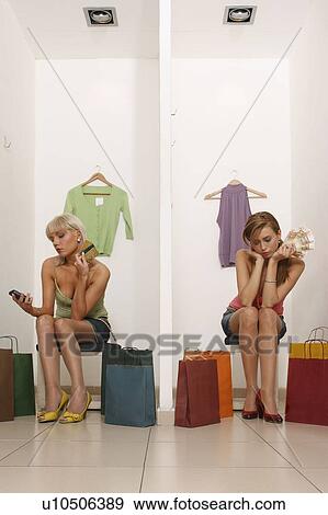 Stock Photo - Young women with credit cards and cash. Fotosearch