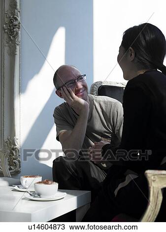 Stock Image - Couple sitting in outdoor café. Fotosearch