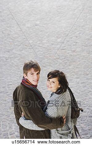 Man and woman looking back at camera. View Large Photo Image Picture - Man and woman looking back at camera.. Fotosearch