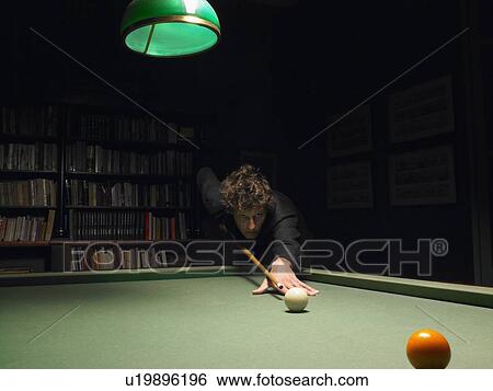 Stock Photograph - Man playing snooker. Fotosearch