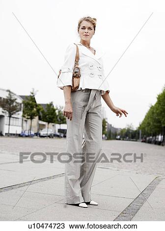 Woman standing outdoors View Large Photo Image Stock Image - Woman standing outdoors . Fotosearch