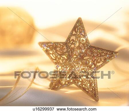 Stock Photo - star shape, yule, decorative piece, vibrant colors, christmastide, golden. Fotosearch
