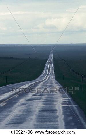 Stock Photograph -  a Country Road, Surrounded By a Flat Green Land, High Angle View. Fotosearch