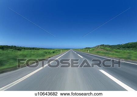 a Country Road, Surrounded By a Green Land Under a Blue Sky, Front View View Large Photo Image Stock Image - a Country Road, Surrounded By a Green Land Under a Blue Sky, Front View. Fotosearch