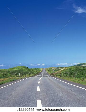 Stock Photography -  a Country Road, Surrounded By Several Grass Hills, High Angle View. Fotosearch